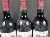 three bottles of wine sitting on top of a table next to each other