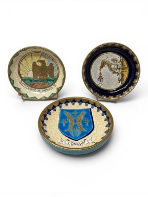 three small plates with a coat of arms and a coat of arms on them