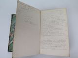 an open book with writing on it sitting on a table
