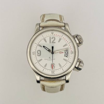 a close up of a watch on a white surface