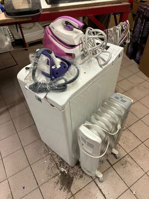 a small refrigerator with a bunch of appliances on top of it