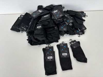 black umbrellas with tags on them sitting on a white table