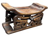 an image of a wooden bench with carvings on top of it