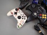 several video game controllers sitting on top of a table next to each other