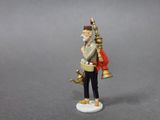 a figurine of a man with a bell and a bag