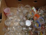 a box full of empty plastic cups and a plastic spoon