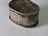 a silver box sitting on top of a white surface
