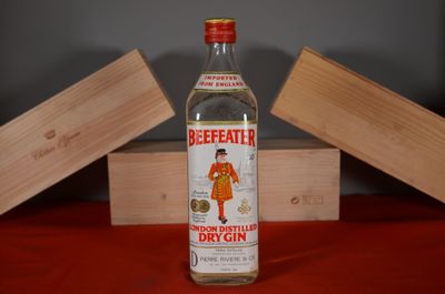 a bottle of beeffatter sitting on a table next to a wooden box