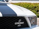 a black and white car parked in front of a house