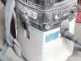 a vacuum that is sitting on the floor next to a hose