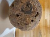 a large rock sitting on a wooden floor next to a door