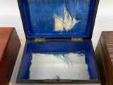 a small wooden box with a painting inside of it
