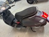 a motor scooter that is parked in a garage
