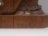 a wooden statue of a man with a hat on