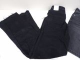 two pairs of black jeans sitting on top of a white table