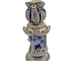 a blue and white vase sitting on top of a table