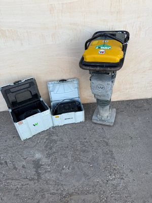 a yellow box and a black box sitting next to a yellow fire hydrant