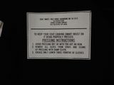 a sign on the back of a black shirt that says to keep your coat drying properly