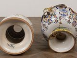 two vases that are sitting on a wooden table
