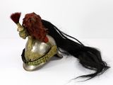 an image of a woman with long hair sitting on top of a helmet