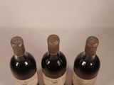 three bottles of wine that are sitting on a table
