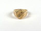 a close up of a gold ring with a man ' s face on it