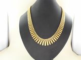 a close up of a necklace on a mannequin display