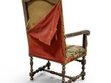 an old chair with a red cloth covering the back of it