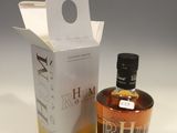 an empty bottle of whisky next to a cardboard box on a table