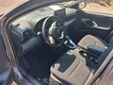 the interior of a car with the door open and the steering wheel down