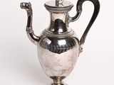 a silver tea pot with a handle on a white background