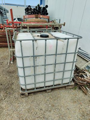 a large container sitting on top of a pallet in the dirt