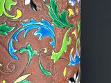 a decorative vase with a bird on it on a black background
