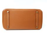 an image of a tan leather purse on a white background