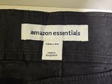 a close up of a label on the back of a pair of black jeans