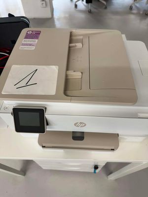 a printer sitting on top of a table in a room