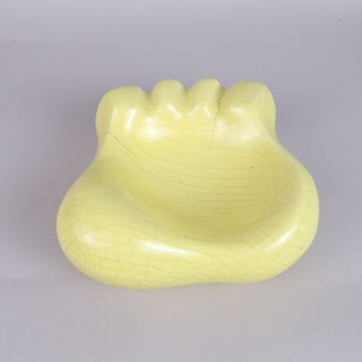 a yellow toothbrush holder on a white surface