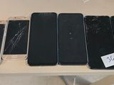several cell phones sitting on top of a table next to each other