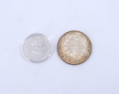 a close up of a coin next to a glass of water