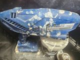 a blue and white model of a space ship on a black surface
