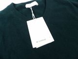 a close up of a black sweater with a white tag on it