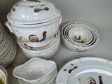 a lot of plates and bowls with roosters painted on them