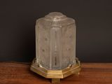 an image of a glass table lamp on a wooden table