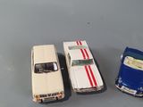 three toy cars sitting next to each other on a table