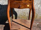a small wooden table with a drawer on top of it