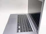 a silver laptop computer sitting on top of a white table