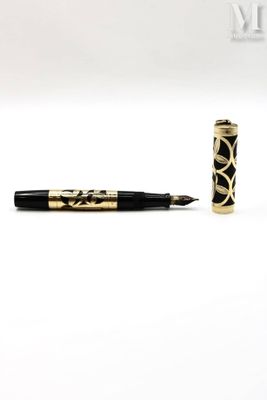 an image of a pen with a black and gold design on it