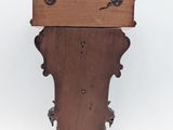 an old wooden clock with a wooden case on it