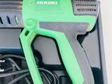 a green and black cordless drill in a case