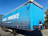 a large blue truck that is parked in the parking lot